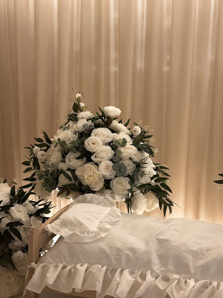 Pet memorial bed surrounded by white roses at a Furwell farewell ceremony