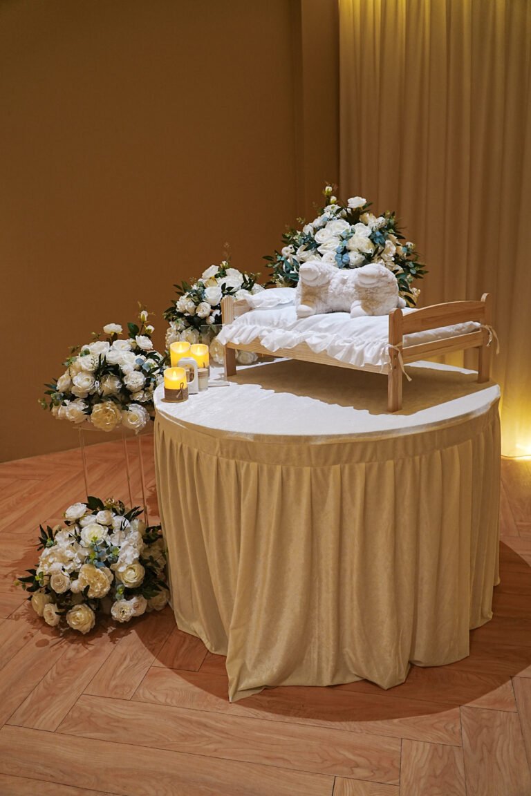 Pet memorial setup with white flowers and candlelight at Furwell