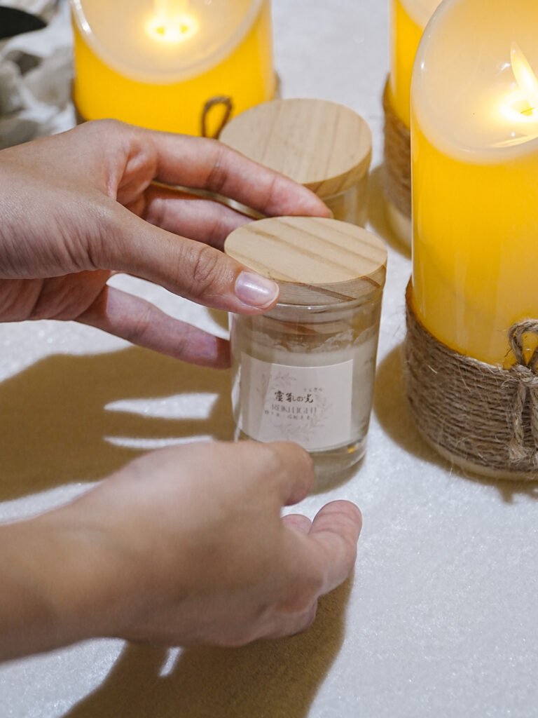 Furwell staff adjusting a pet keepsake jar beside memorial candles